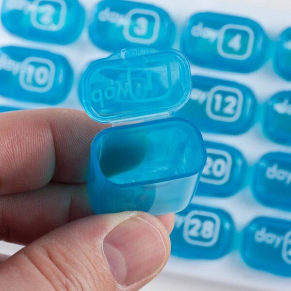 GMS Pop Out 31 Day Pill Organizer Hand Holding one Pop Out Pill Pod Open Empty