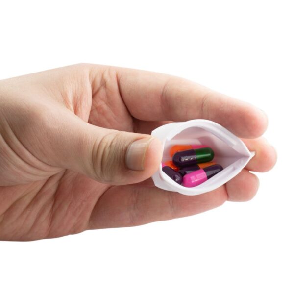 GMS Squeezable Pill Case in Person's Hand